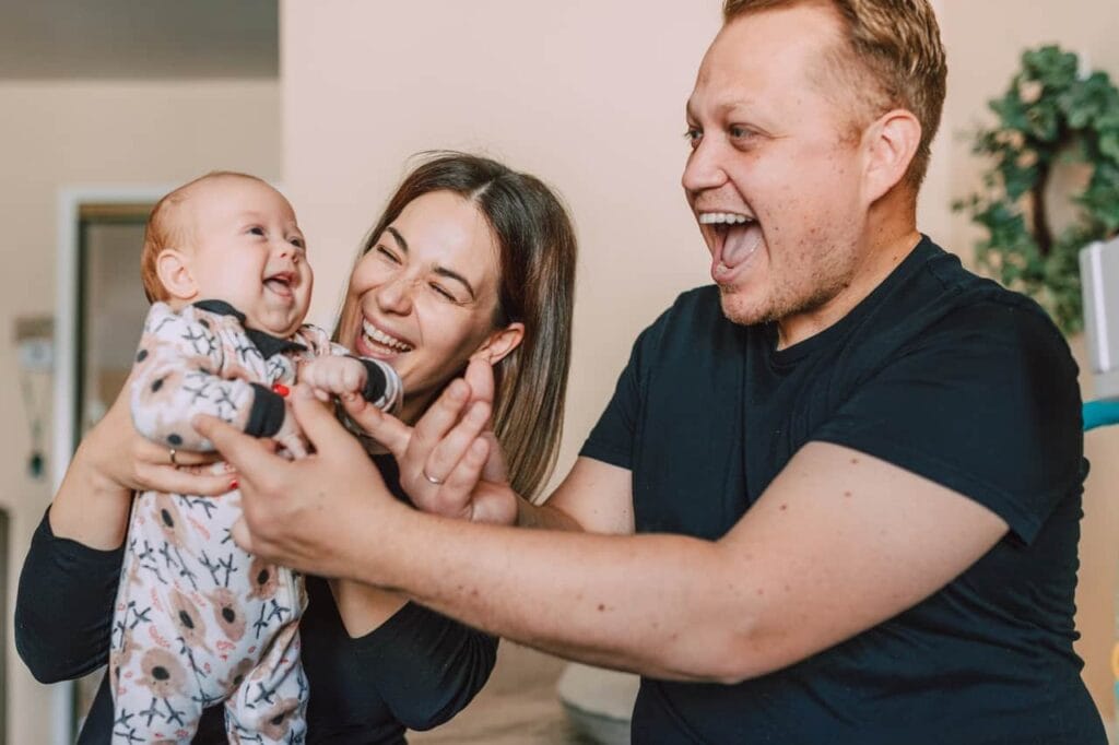 parents holding new baby