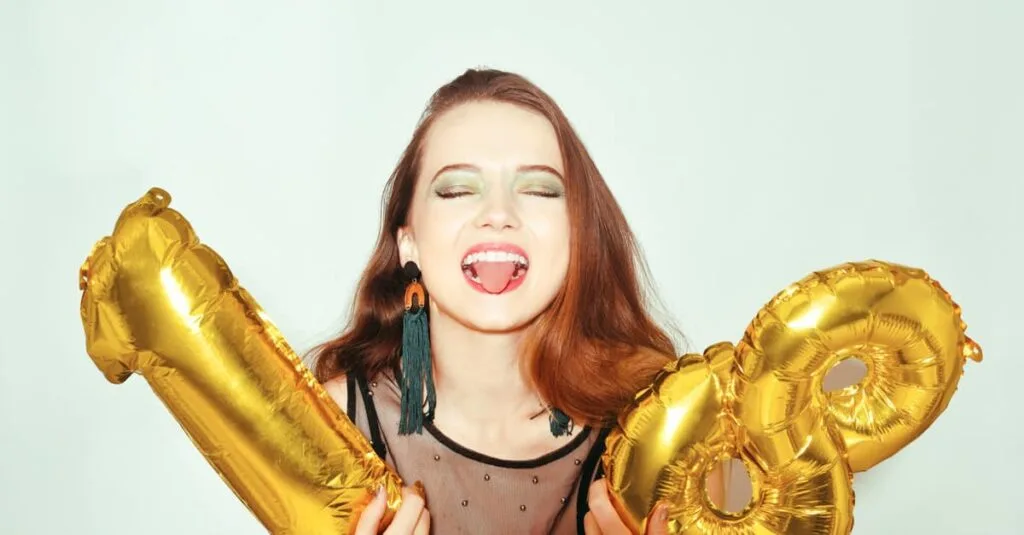 Young-woman-holding-18th-birthday-balloons