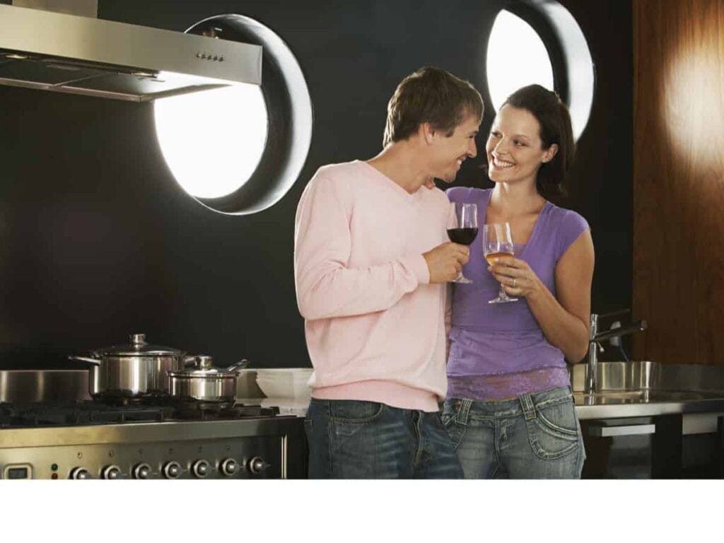 Couple drinking wine in kitchen
