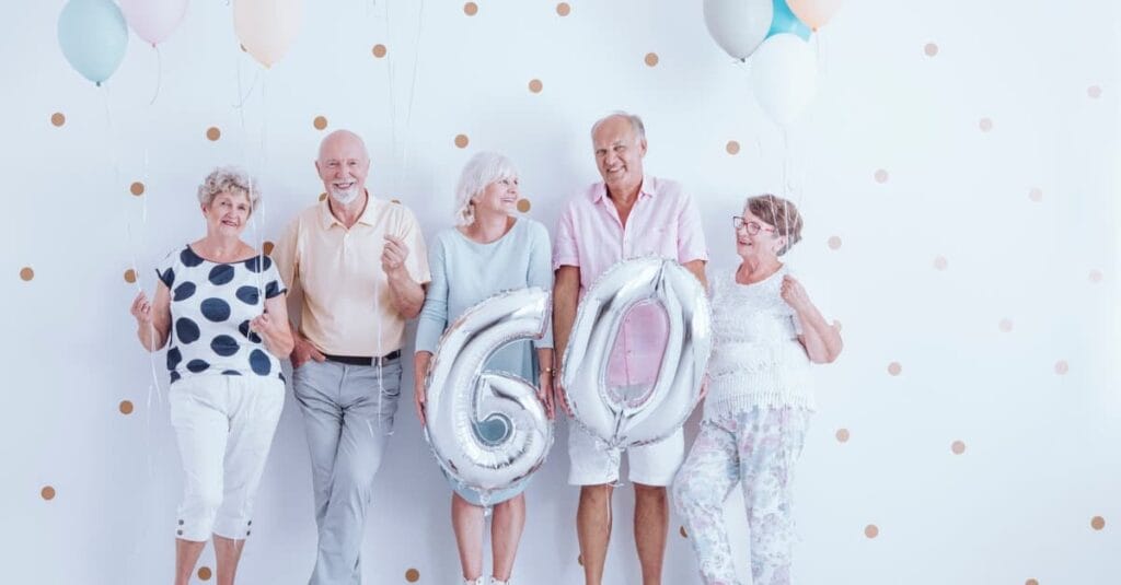 seniors-celebrating-a-60th-birthday-with-number-balloons
